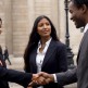 Black woman and black man shake hands