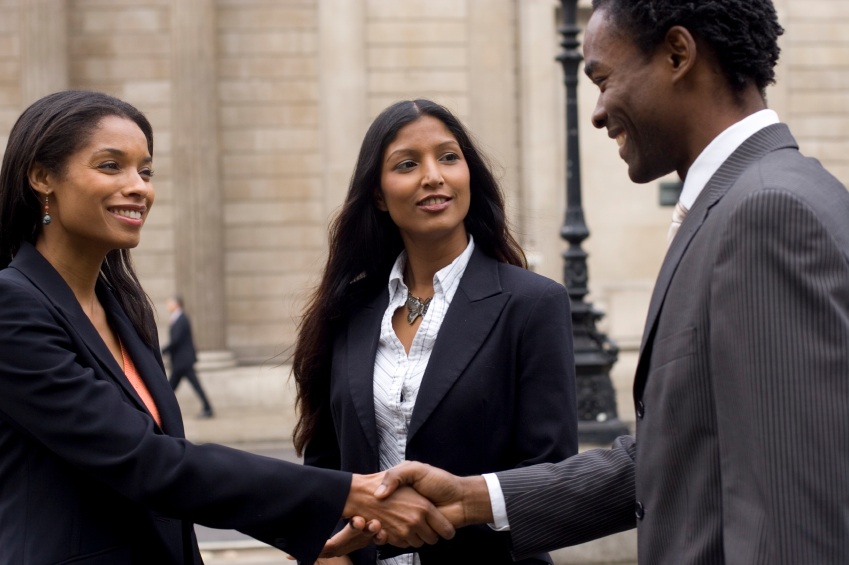 Black woman and black man shake hands