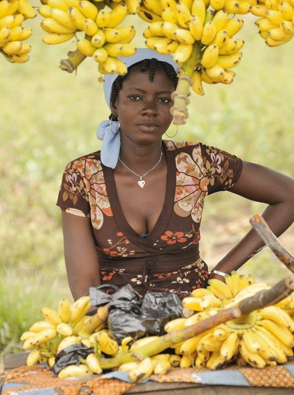 beautiful african lady selling banana at her shop