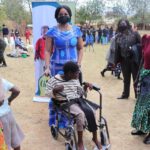 Mary Chilima Helping A Child