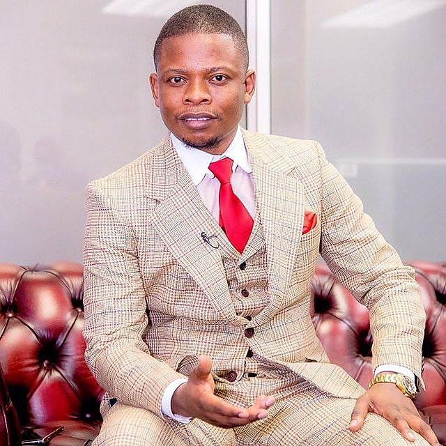 Shepherd Bushiri Brown Suit With Red Tie