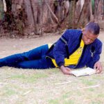 Shepherd Bushiri Reading Outside